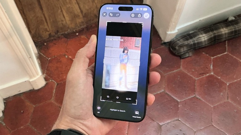 A hand holding an iPhone
