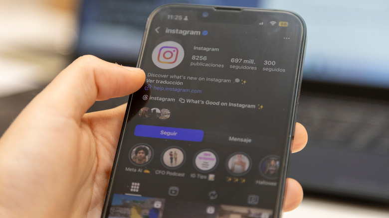 Person browsing Instagram app on phone with dark mode