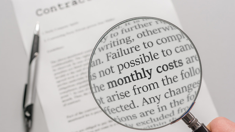 fine print on a contract with a magnifying glass