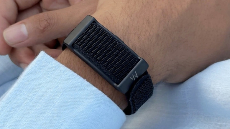 A person with a Whoop tracker on their wrist.