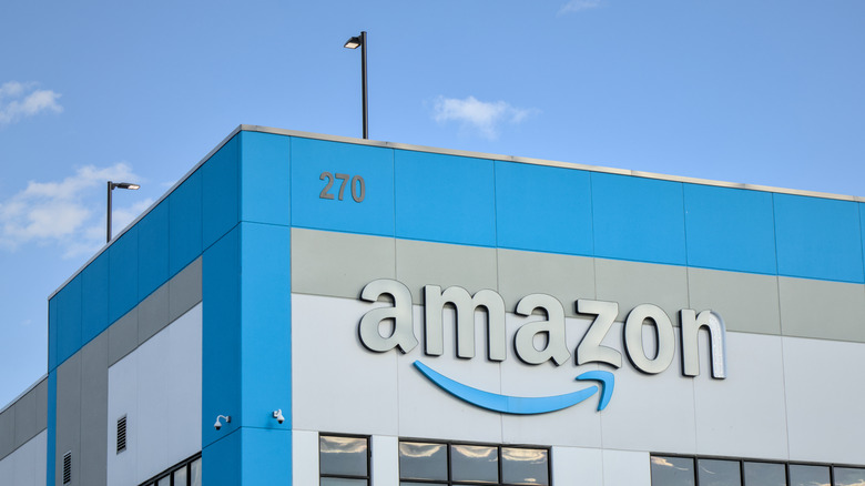 An Amazon warehouse with the company logo on the building.