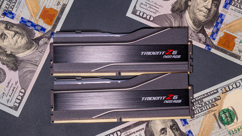 two sticks of ram sitting in between hundred dollar bills