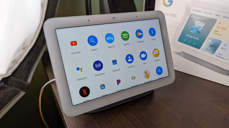 Photo of a Google Nest Hub with a box in the background.