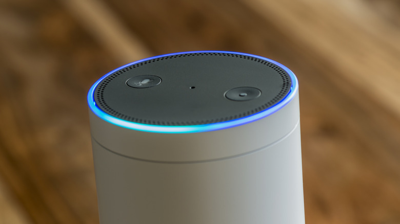 An image of an Amazon Echo Plus, specifically showcasing its LED light that's flashing blue and cyan