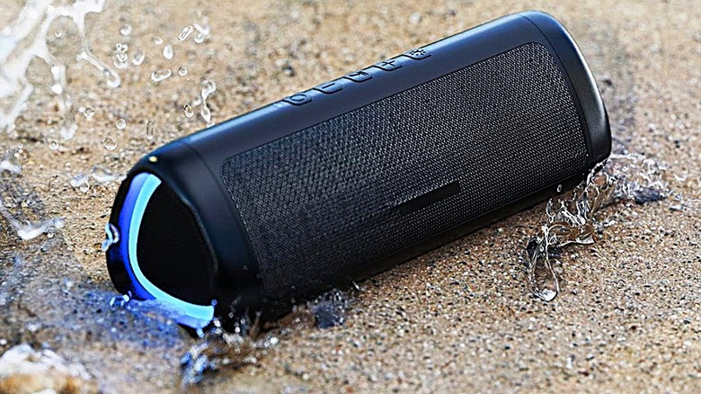 BolaButty Bluetooth speaker in the sand with RGB on.