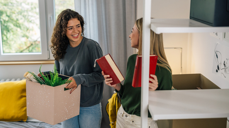 Two young women in a university dorm laughing