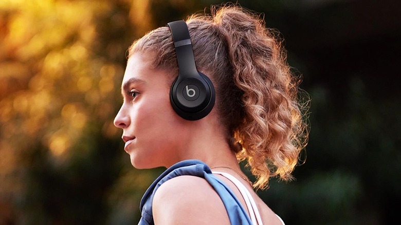 Woman wearing the Beats Solo 4 wireless headphones.