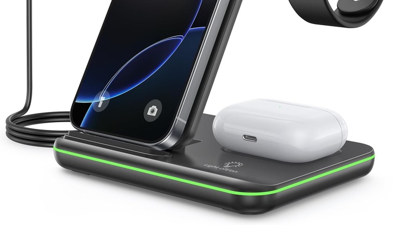 a phone, smartwatch and earbuds on a 3-in-1 wireless charger