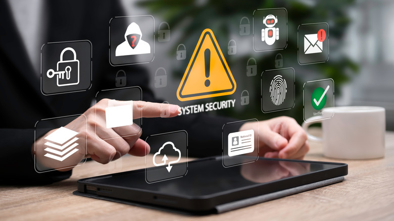 Security and scammer icons positioned above a tablet.