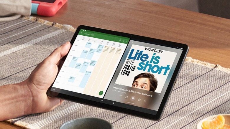 Person uses the Amazon Fire Tablet Max 11 while drinking a cup of coffee