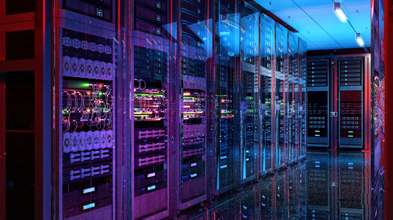 A data center is pictured, with racks of computers and servers all lined up.
