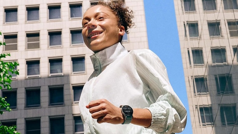 Woman wearing Samsung Galaxy Watch 7 on wrist while running.
