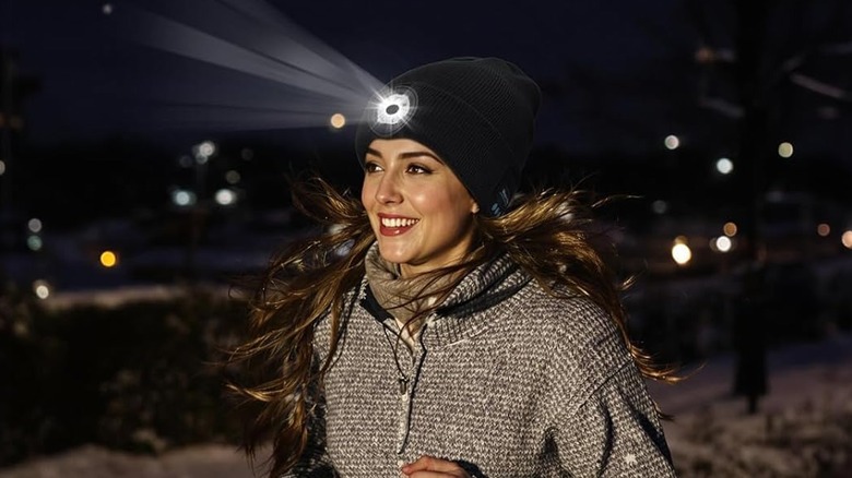 Woman running with Topiei hat on at night