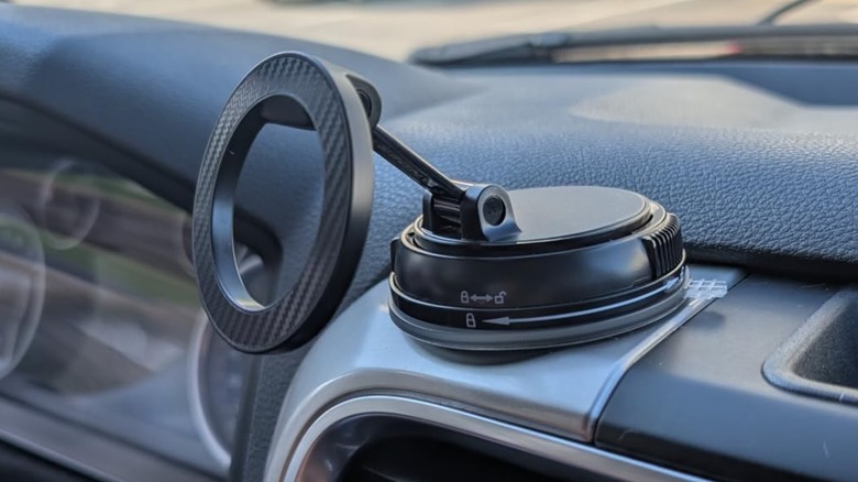 A photo from a customer's review of the Andery Car Phone Holder with MagSafe, the holder is attached to the top of a vehicle's dashboard