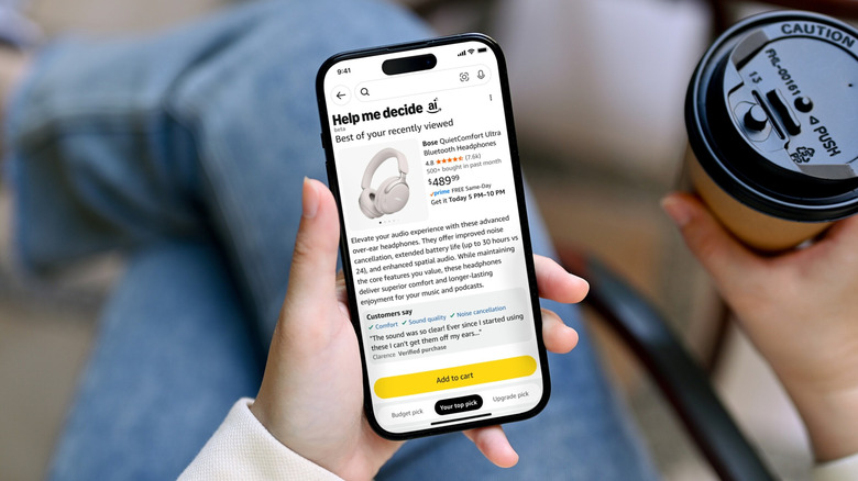 person holding smartphone with Amazon Help me decide tool recommendation showing, holding a coffee cup
