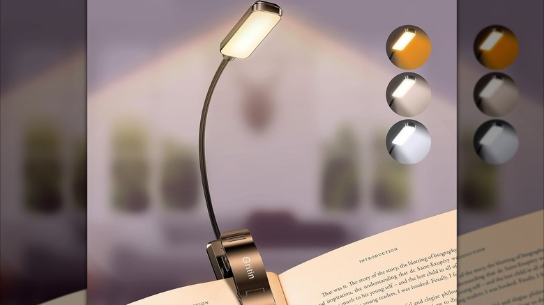 A picture of a clip-on reading light attached to a book