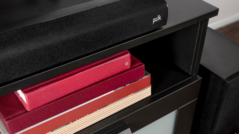 The Polk Audio Signa S2 Soundbar set up on a stand, placed next to its wireless subwoofer.
