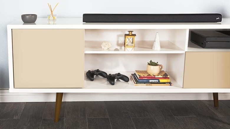 The Polk Audio Signa S2 placed on top of a TV stand.