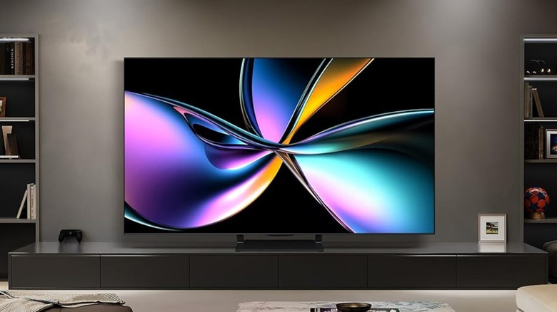 A promotional photo of the Hisense 55-inch 4K smart TV, the TV is displaying vivid colors as it sits atop a long TV stand
