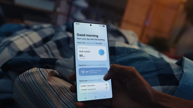 Hand holding Samsung Galaxy S25 Ultra in bed