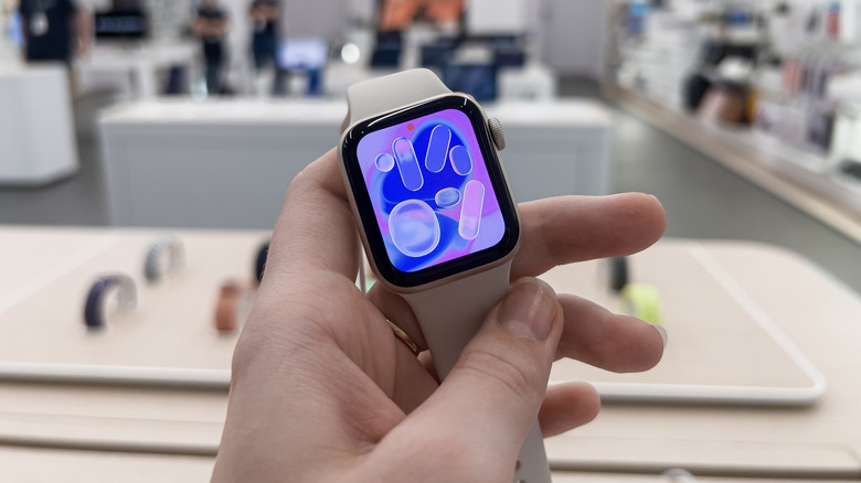 Apple Watch SE 3 held up in Apple Store.