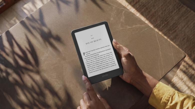 The new Kindle Paperwhite being held above a table