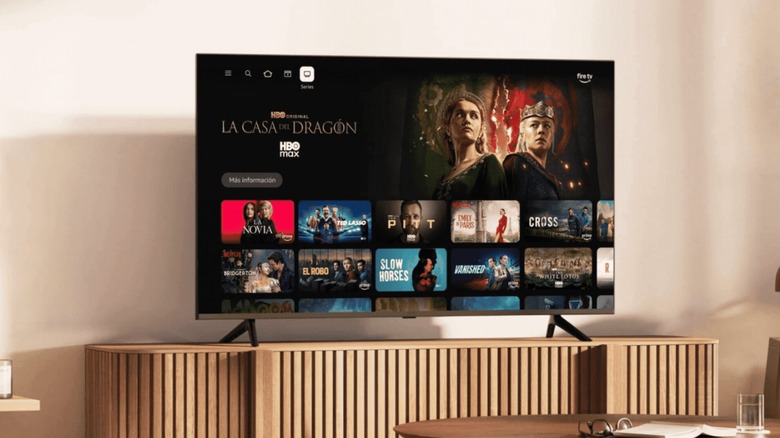 A TV displaying the new Amazon Fire TV UI, which shows several movies on the screen