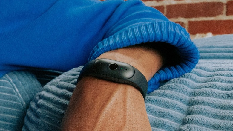 Close-up of a person wearing the Bee Frontier AI device on their wrist