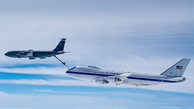 A Nightwatch airplane is tethered to a smaller jet as it refuels.