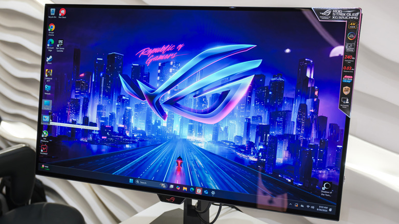 Picture of an OLED PC monitor with a bright neon blue and pink wallpaper