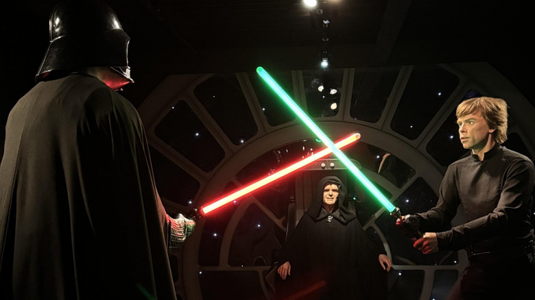 Wax figures of Darth Vader and Luke Skywalker battling with light sabers