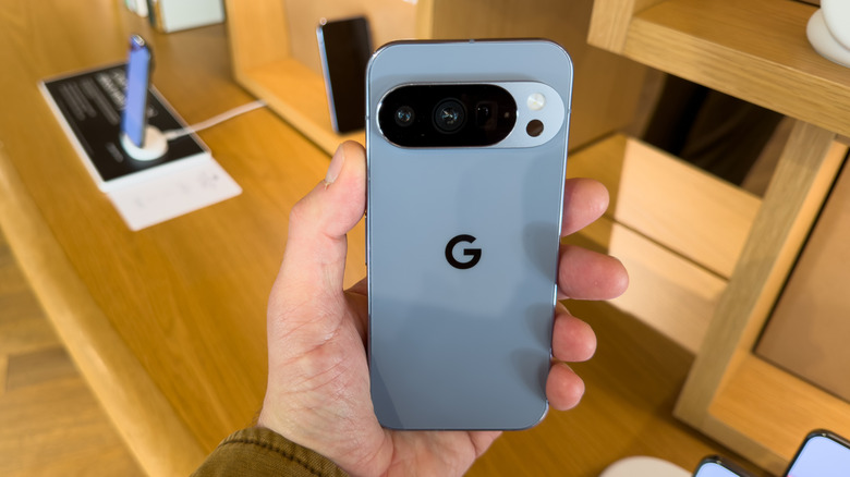 Close-up of a person holding a Google Pixel phone, showing its back