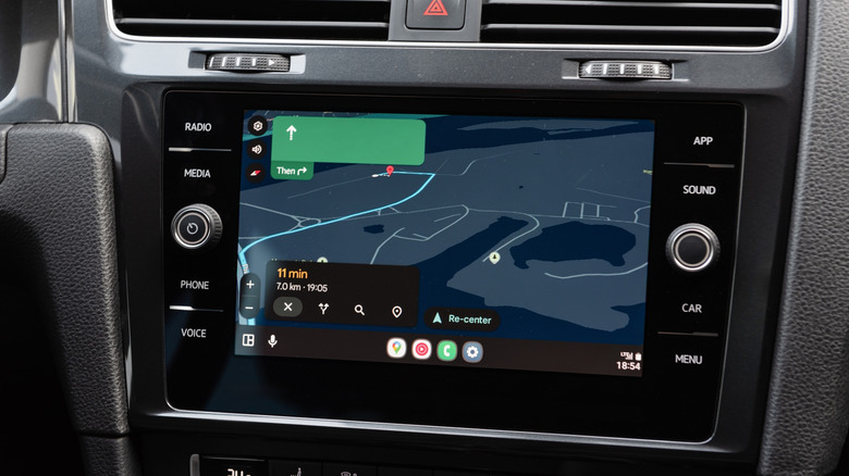 Close-up shot of an infotainment system with Android Auto showing Google Maps navigation