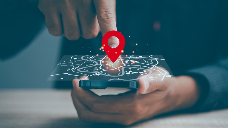 Concept of man sharing precise location with maps concept hovering over a smartphone