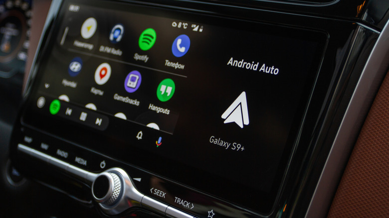 A vehicle's infotainment screen displaying a number of app icons within Android Auto
