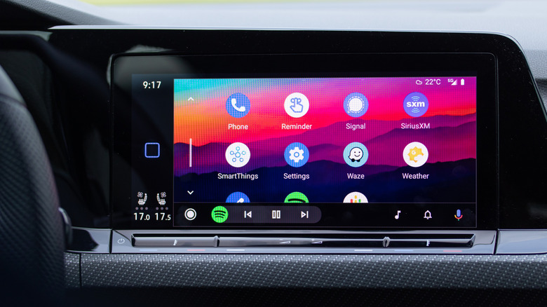 A vehicle's infotainment screen showcasing the home screen of Android Auto with Phone and Waze apps visible