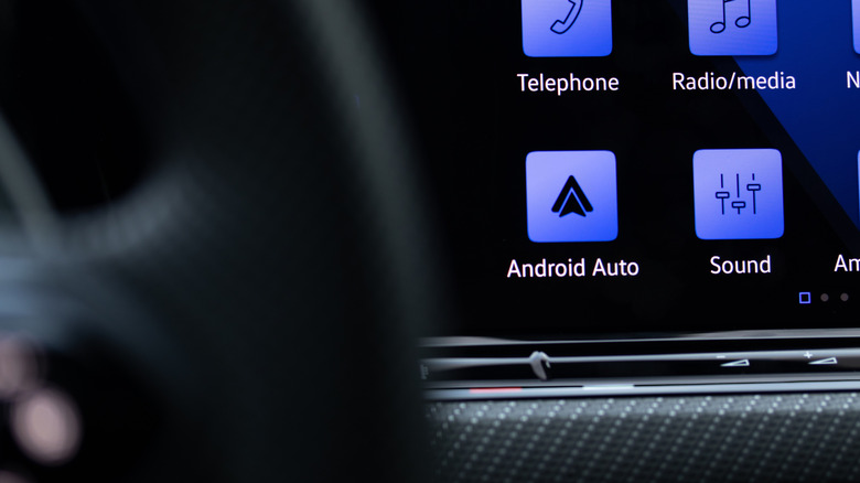Android Auto icon closeup on the dashboard display of a luxury vehicle.