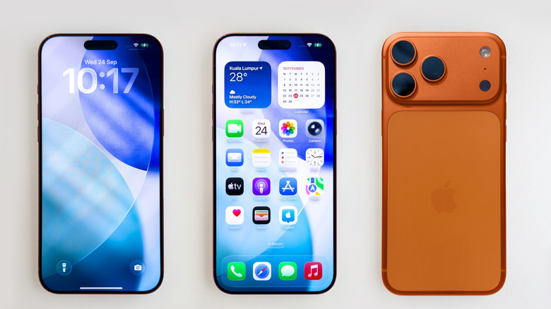 Three iPhones lying side by side with two of them showing the screen and one showing the back