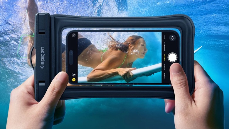 person taking photo underwater through pouch