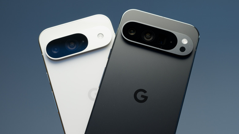 A white Google Pixel 9 and a black Google Pixel 9 side-by-side against a gray background