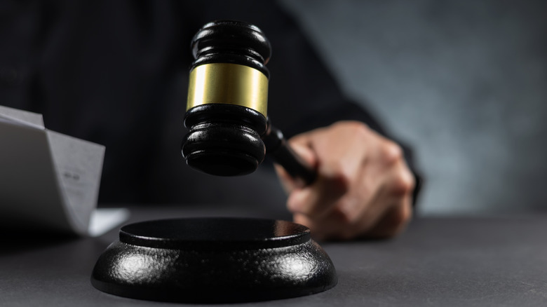 Judge gavel getting ready to land on base for ruling.