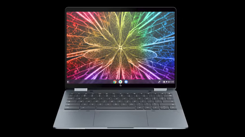 A rainbow, psychedelic flower is vibrantly shown on a silver HP Elite Dragonfly Chromebook before a black background.