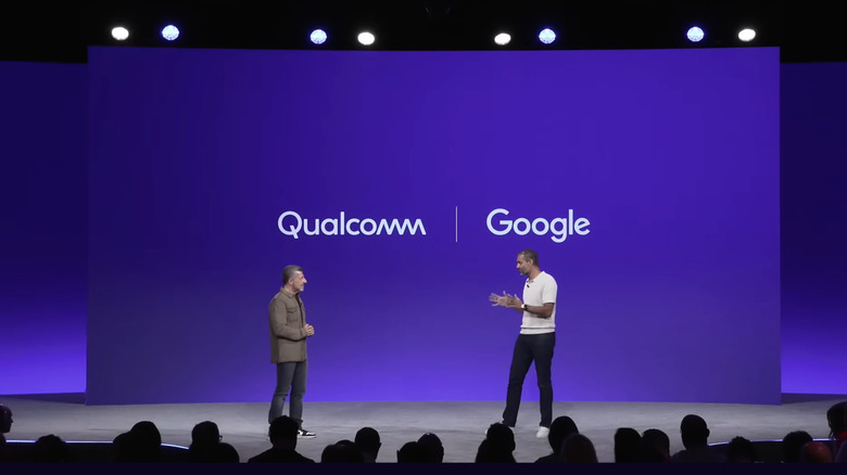 Android head Sameer Samat (right) discusses Aluminum OS with Alex Katouzian, Snapdragon's General Manager for Mobile (left) on a stage before a purple background with the Qualcomm and Google logos side by side in white.