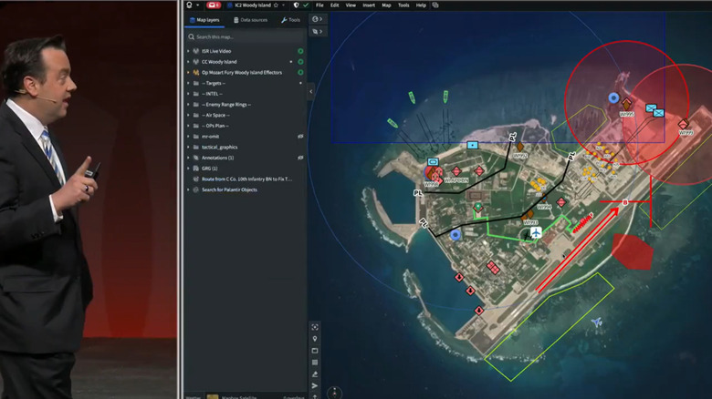 Cameron Stanley, Chief Digital and Artificial Intelligence Officer of the Defense Department, showcases Palantir's Maven Smart System, showing a top-level view of an island with multiple threat vectors highlighted