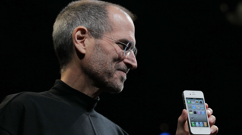 Steve Jobs holding the iPhone 4 at the keynote opening event