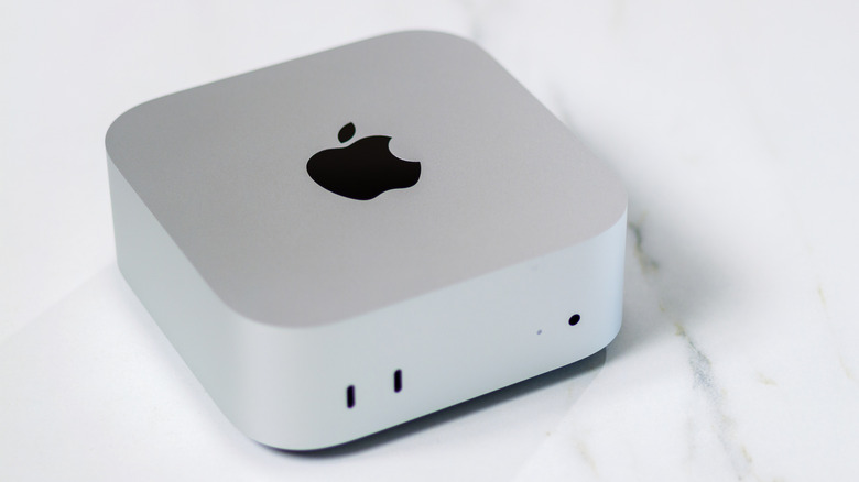 A silver Mac mini sitting on what appears to be a marble countertop