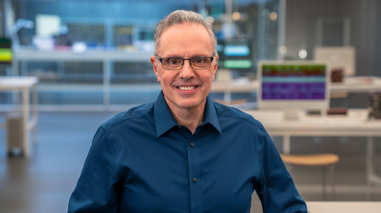 Johny Srouji, Apple's chief hardware officer, standing in a computer lab.
