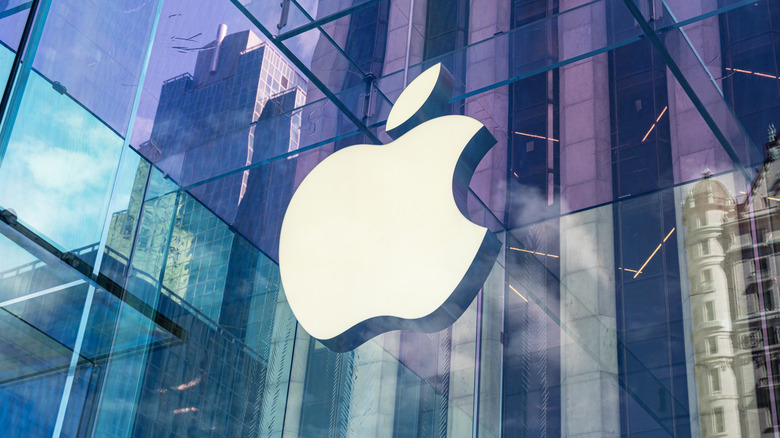 The Apple logo on a glass building