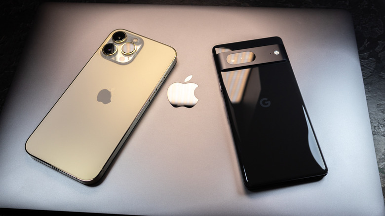 An iPhone and a Pixel phone placed on top of a MacBook.