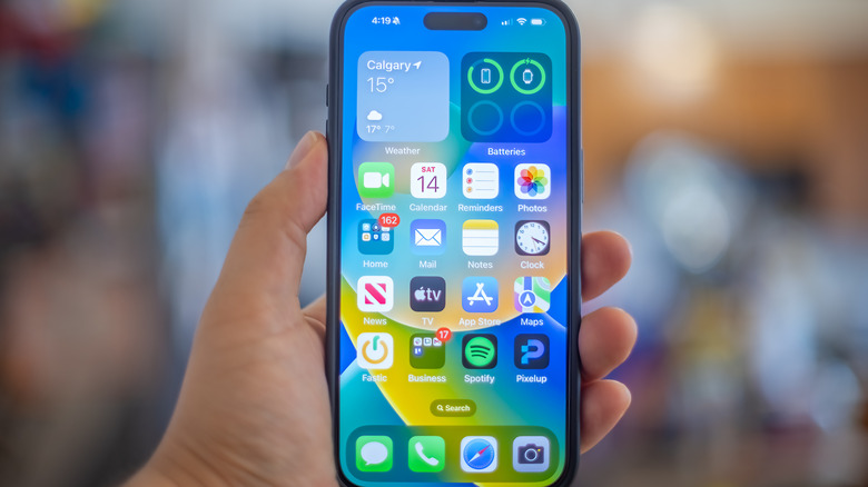 An iPhone display showing various apps on the home screen